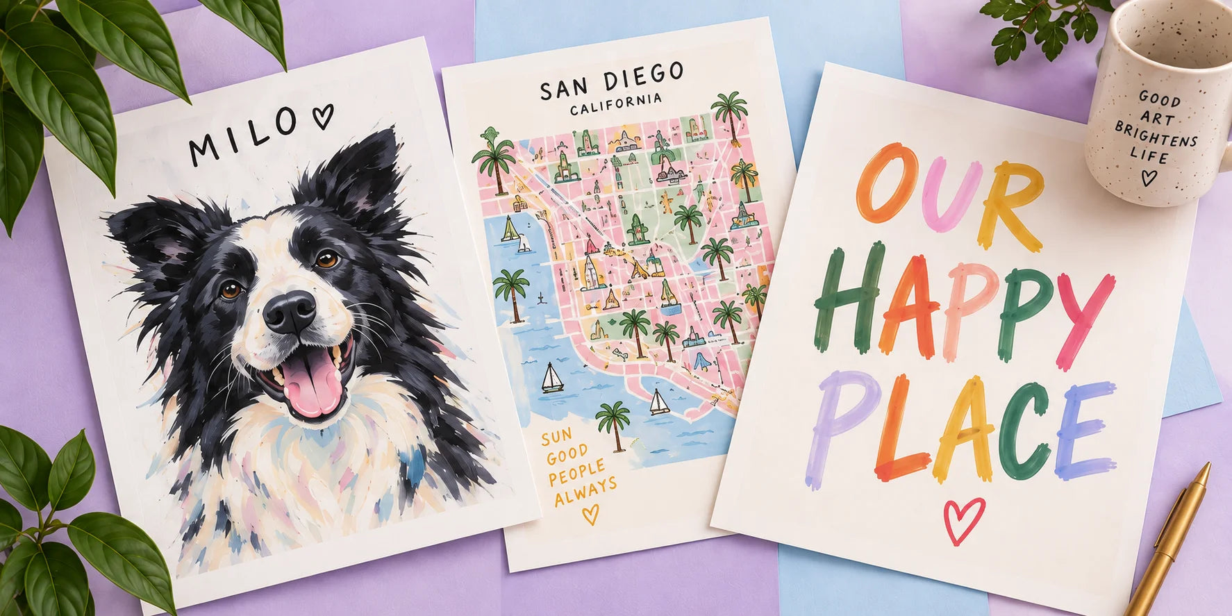 A pet portrait, an illustrated San Diego map and an Our Happy Place print on a pastel studio tabletop